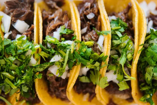 An order of tacos complete with cilantro and onion