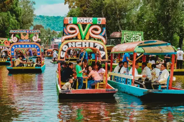A photo of many trajineras on the canals at Xochimilco